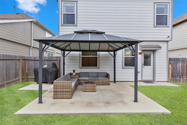 back of property featuring a fenced backyard, outdoor lounge area, a yard, a gazebo, and a patio area