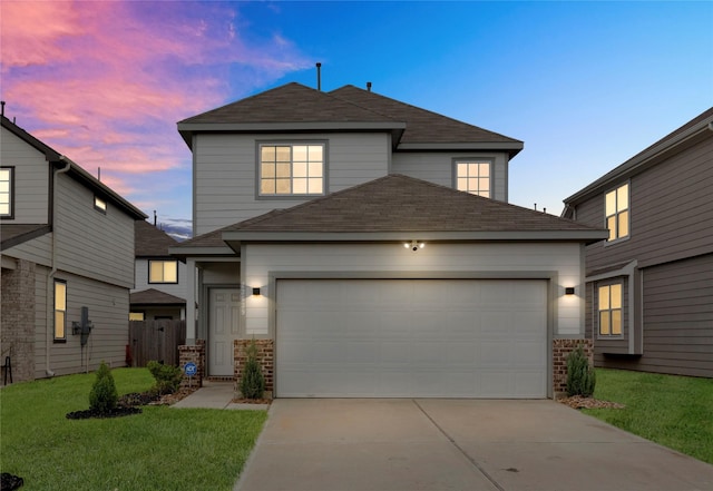 traditional-style home featuring a front yard, concrete driveway, brick siding, and an attached garage