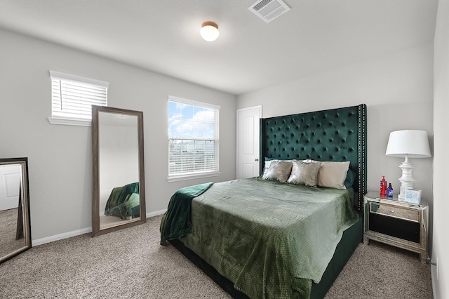 carpeted bedroom with visible vents and baseboards