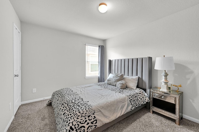 bedroom featuring carpet and baseboards