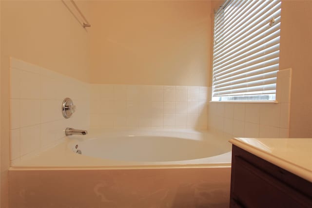 bathroom featuring a garden tub and vanity