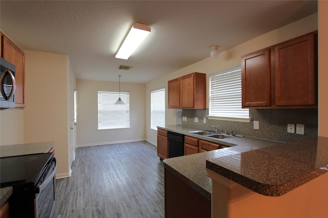 kitchen with black dishwasher, tasteful backsplash, visible vents, electric range, and a sink