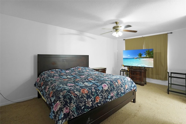 bedroom featuring a ceiling fan, light carpet, and baseboards