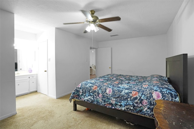 bedroom with a textured ceiling, light carpet, a ceiling fan, visible vents, and baseboards