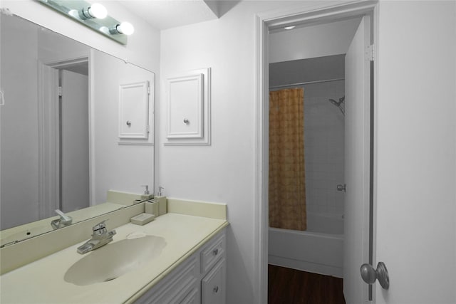 full bath featuring shower / tub combo, wood finished floors, and vanity