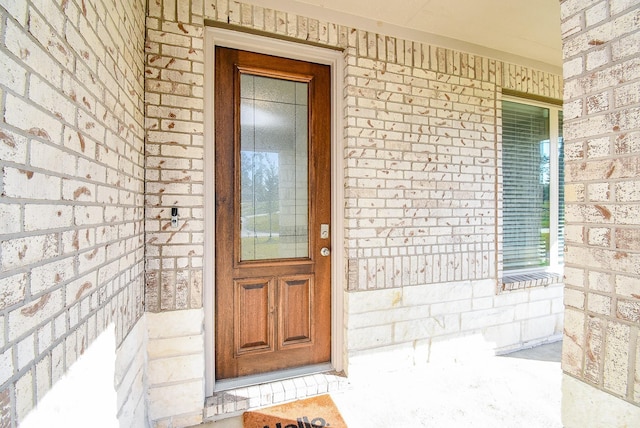 property entrance with brick siding