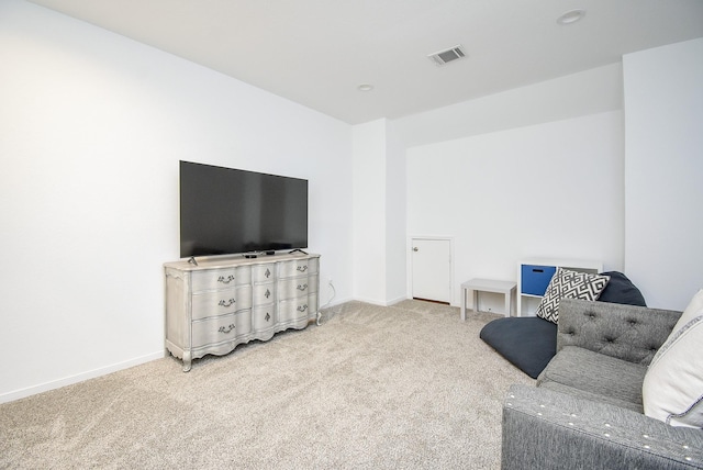 living room featuring carpet, visible vents, and baseboards