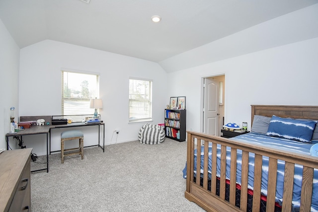 carpeted bedroom with lofted ceiling and baseboards