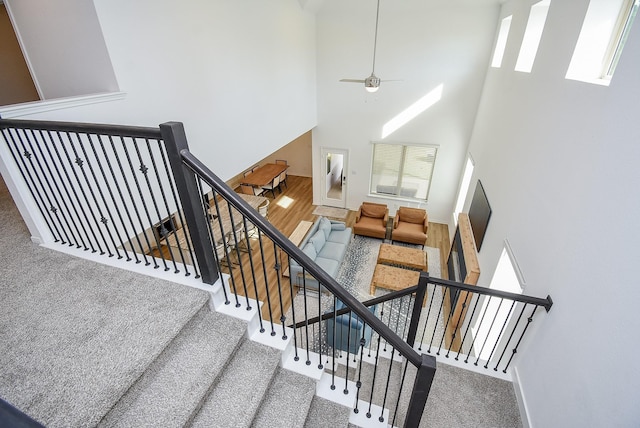 130 Leila Ln, New Waverly, TX 77358 - stairway featuring baseboards, a high ceiling, and a ceiling fan