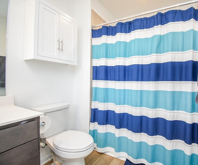 130 Leila Ln, New Waverly, TX 77358 - bathroom featuring toilet, curtained shower, wood finished floors, and vanity