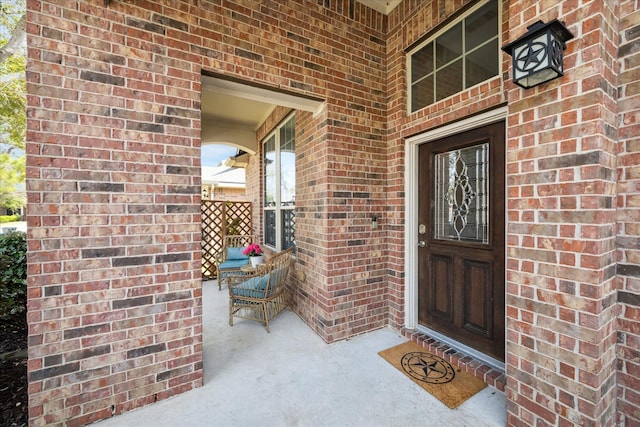 entrance to property featuring brick siding