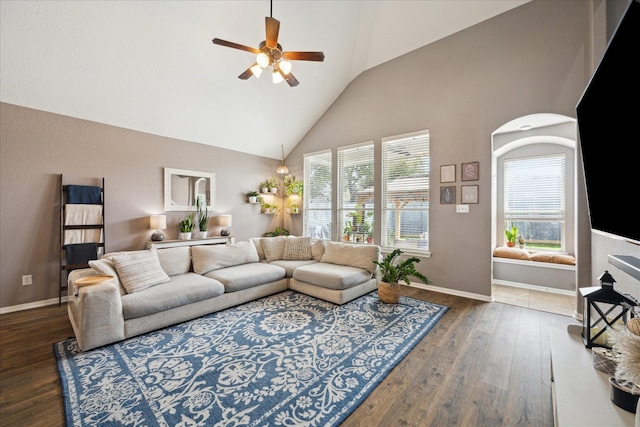 living room with a ceiling fan, baseboards, high vaulted ceiling, and hardwood / wood-style floors