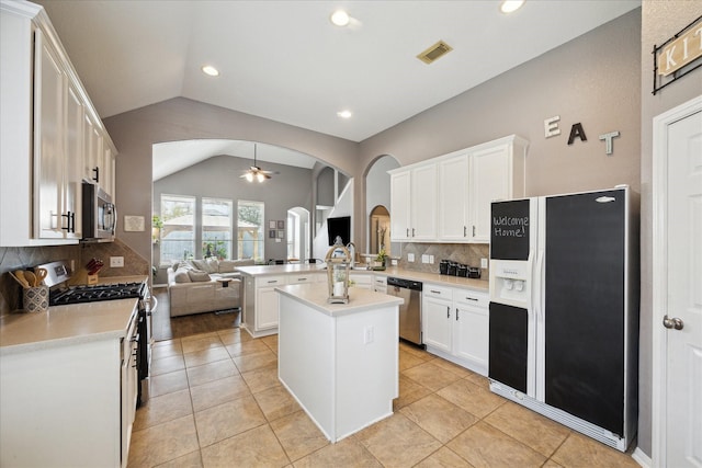 kitchen with visible vents, arched walkways, appliances with stainless steel finishes, open floor plan, and a peninsula