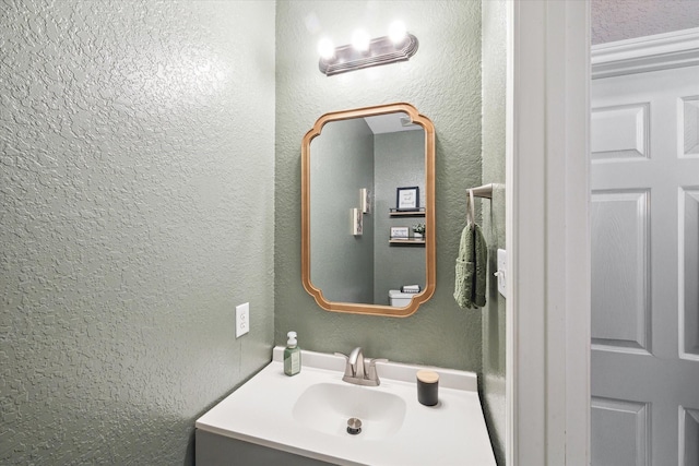 bathroom with vanity and a textured wall