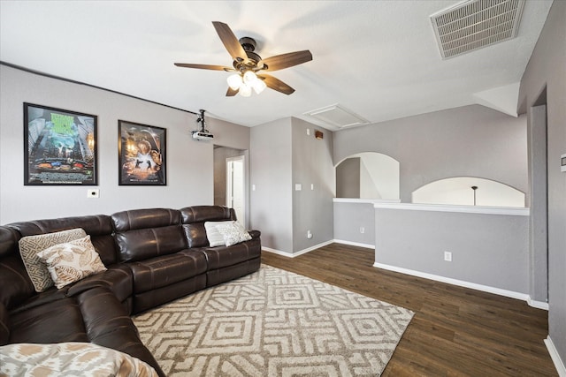 living area with visible vents, ceiling fan, baseboards, and wood finished floors