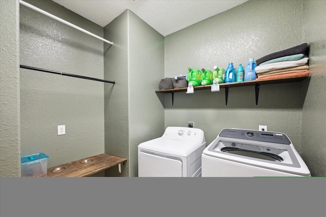 laundry area featuring a textured wall, laundry area, and independent washer and dryer