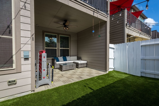 view of patio / terrace featuring ceiling fan, outdoor lounge area, fence, and a balcony