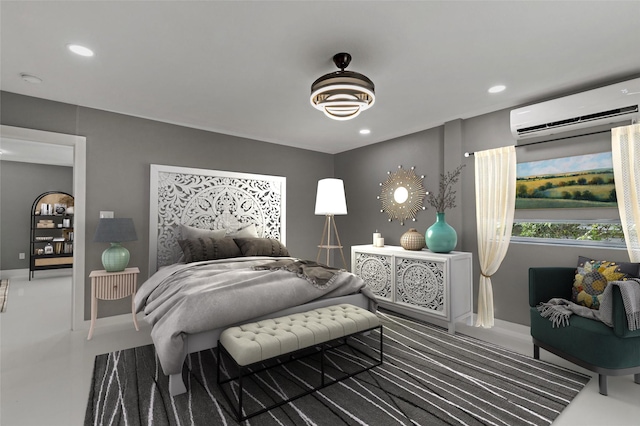 bedroom with recessed lighting, a wall mounted AC, and baseboards