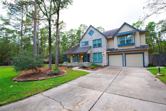 craftsman inspired home featuring an attached garage, covered porch, stone siding, concrete driveway, and a front yard