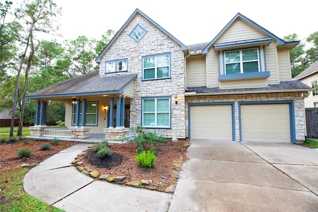 view of front of home with covered porch, driveway, roof with shingles, and an attached garage