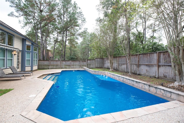 view of pool featuring french doors, a patio area, a fenced backyard, and a fenced in pool