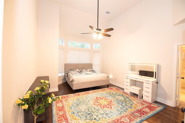 bedroom featuring visible vents, baseboards, ceiling fan, wood finished floors, and high vaulted ceiling