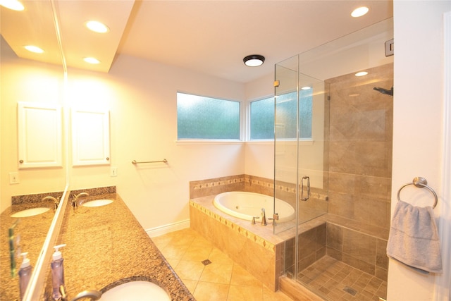 full bathroom featuring double vanity, a stall shower, a bath, tile patterned flooring, and a sink