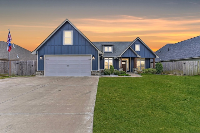 view of front of property with driveway, roof with shingles, fence, board and batten siding, and a front yard