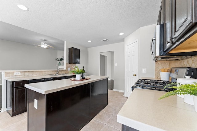 kitchen featuring a sink, visible vents, light countertops, appliances with stainless steel finishes, and decorative backsplash