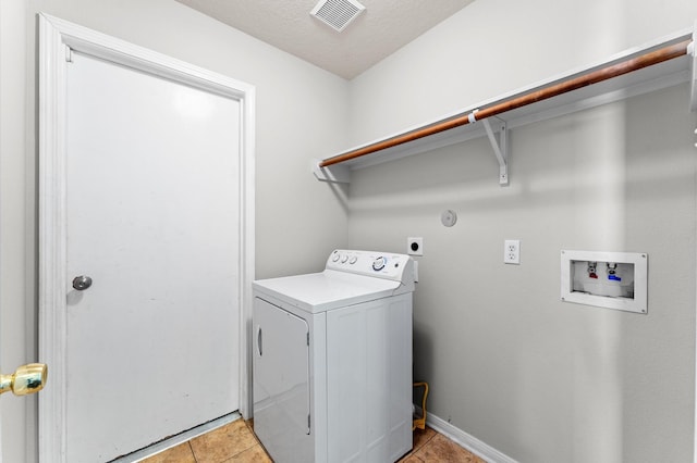 laundry room with laundry area, washer / clothes dryer, light tile patterned flooring, and visible vents