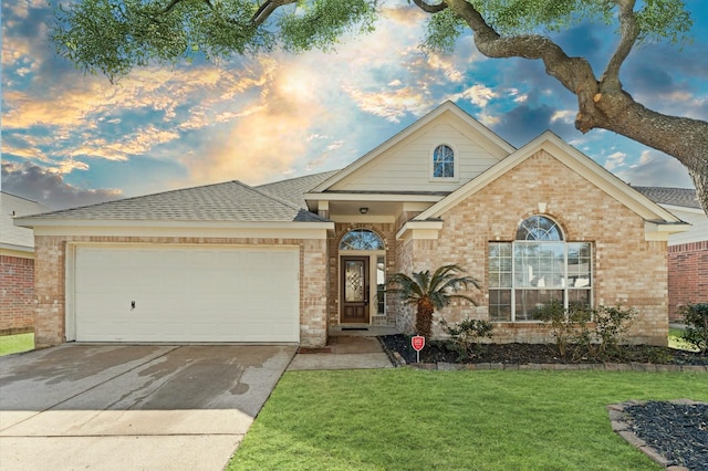 single story home featuring brick siding, a shingled roof, concrete driveway, a lawn, and an attached garage