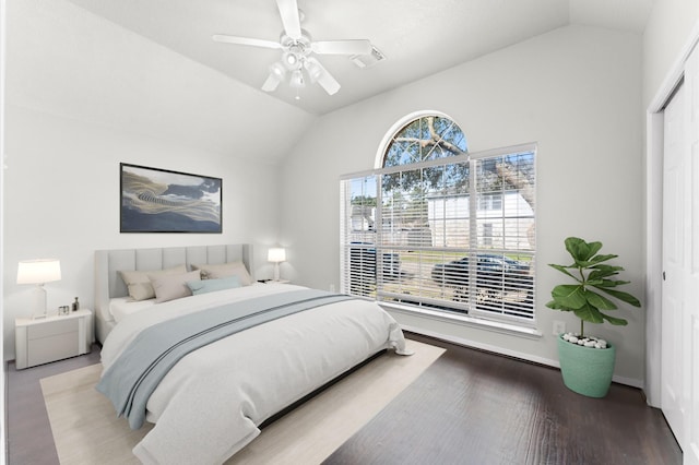 bedroom with ceiling fan, a closet, vaulted ceiling, and wood finished floors