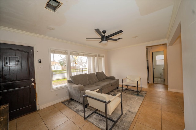 living room featuring light tile patterned floors, visible vents, ornamental molding, ceiling fan, and baseboards