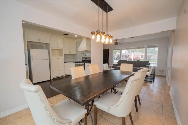 dining space with light tile patterned flooring, visible vents, and baseboards