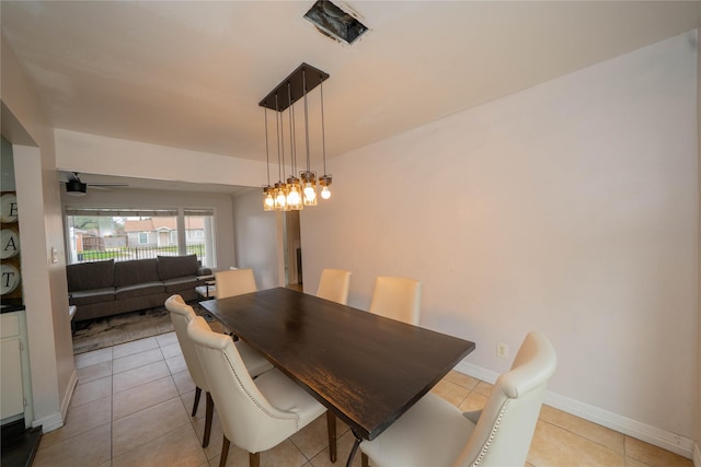 dining area with a ceiling fan, light tile patterned flooring, and baseboards