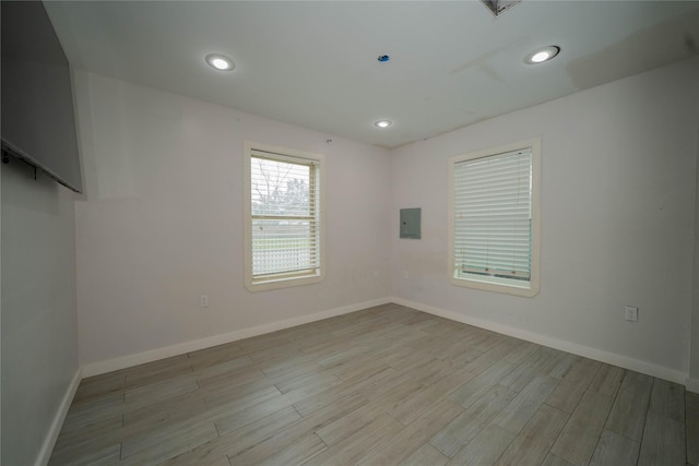 spare room with recessed lighting, wood finished floors, and baseboards