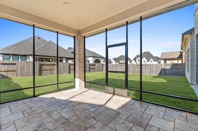 unfurnished sunroom featuring a residential view