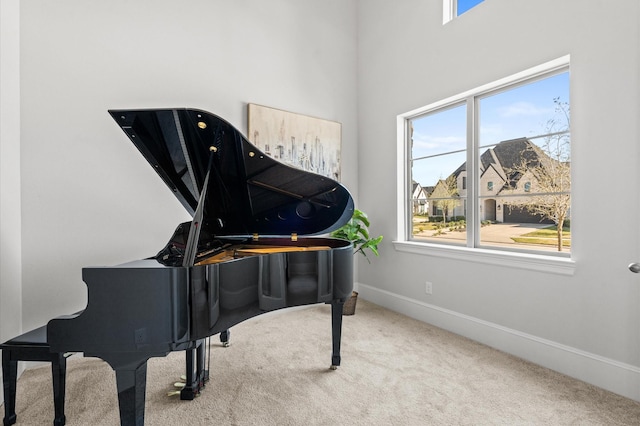 sitting room featuring carpet and baseboards