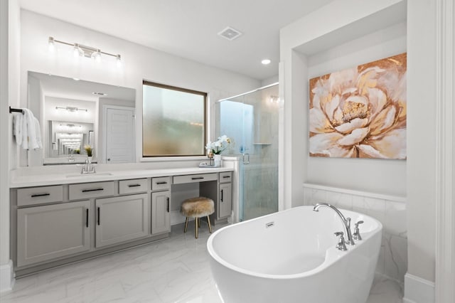 bathroom featuring visible vents, a soaking tub, marble finish floor, vanity, and a shower stall