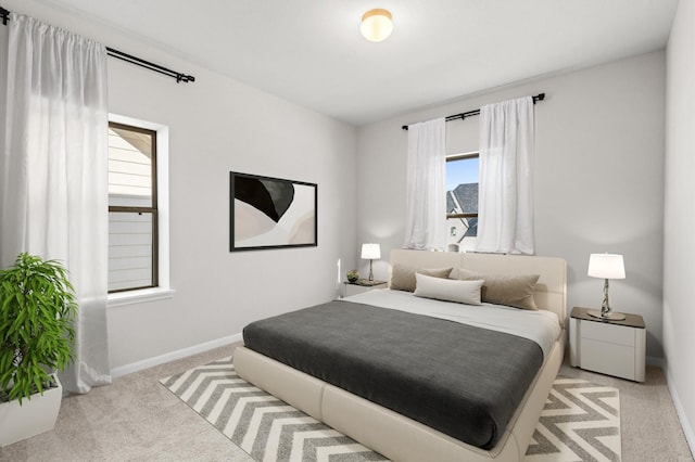 carpeted bedroom featuring baseboards