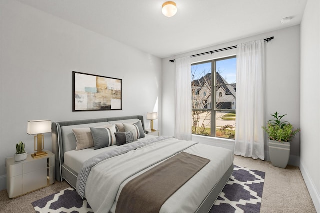 carpeted bedroom with baseboards