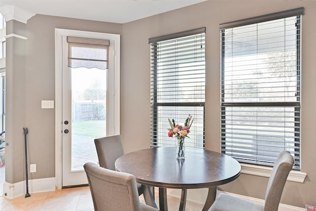 dining area with light tile patterned flooring and baseboards