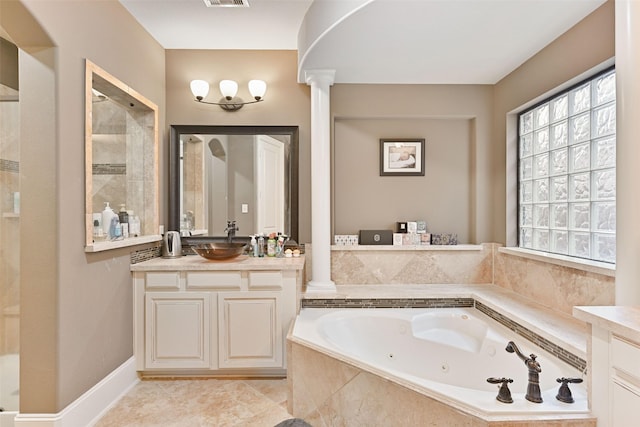 bathroom featuring a whirlpool tub, ornate columns, a shower stall, and vanity