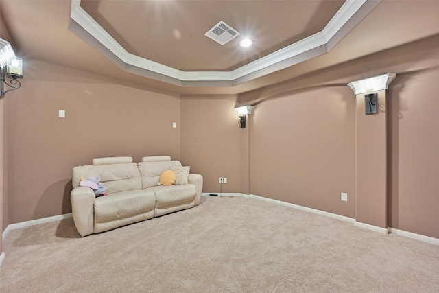 carpeted cinema room featuring ornamental molding, a raised ceiling, visible vents, and baseboards