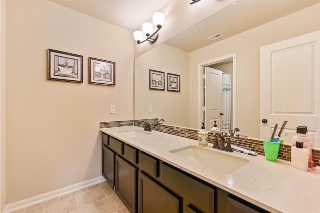 full bath with backsplash, a sink, and visible vents