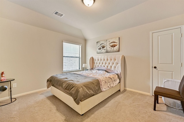 bedroom with vaulted ceiling, baseboards, visible vents, and light colored carpet