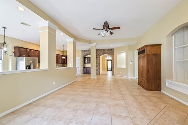 unfurnished room featuring ornate columns, ceiling fan, visible vents, and baseboards