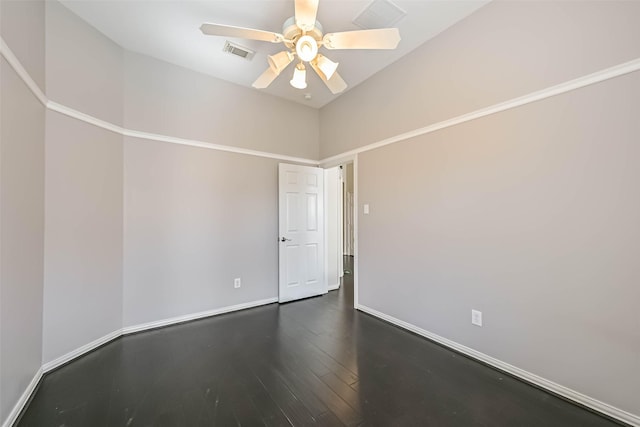 unfurnished room featuring dark wood-style floors, ceiling fan, visible vents, and baseboards