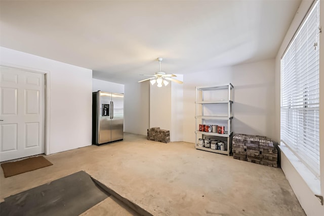 living area with concrete floors and a ceiling fan