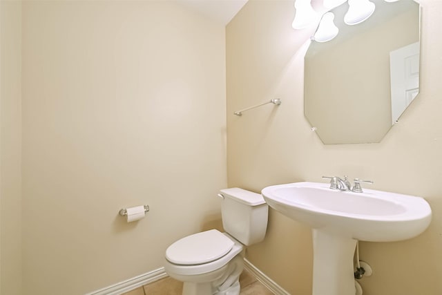 bathroom with tile patterned floors, toilet, and baseboards